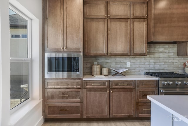 kitchen with light countertops, tasteful backsplash, and stainless steel appliances