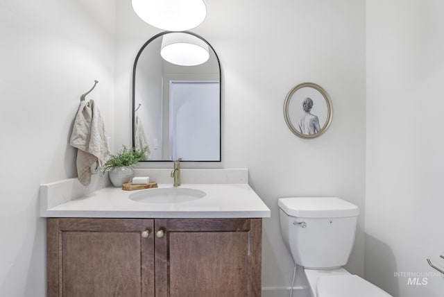 half bathroom featuring toilet and vanity