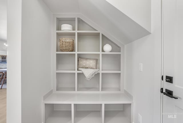 mudroom featuring vaulted ceiling and built in features