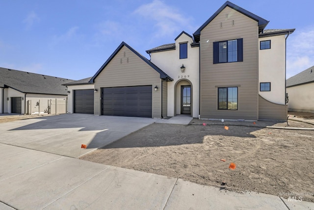traditional-style house with an attached garage and concrete driveway