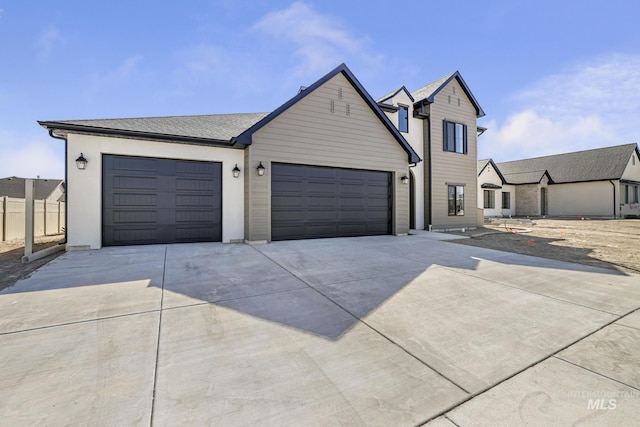 view of front of property featuring a garage and concrete driveway