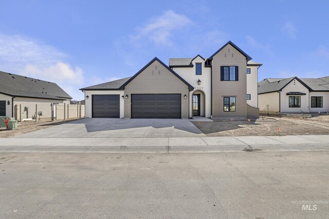 view of front of property featuring a garage and driveway