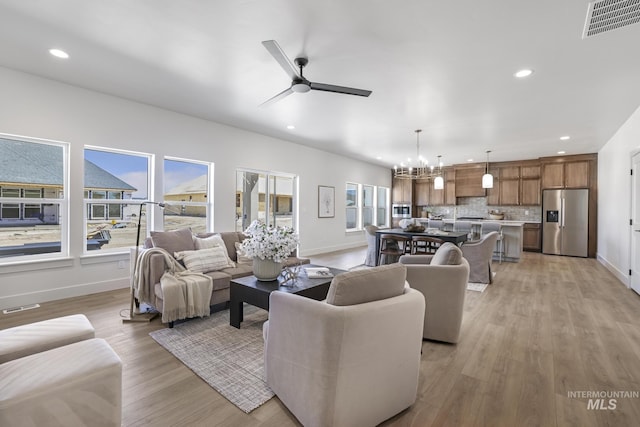 living room with recessed lighting, visible vents, and baseboards