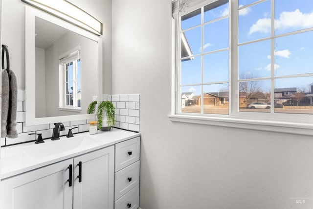 bathroom with tasteful backsplash and vanity