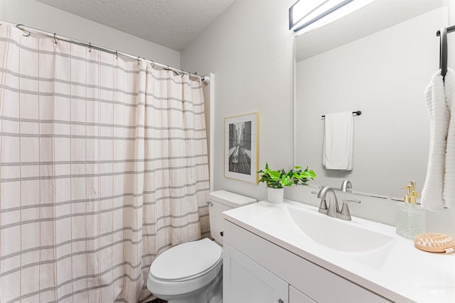 bathroom with toilet, a shower with shower curtain, a textured ceiling, and vanity