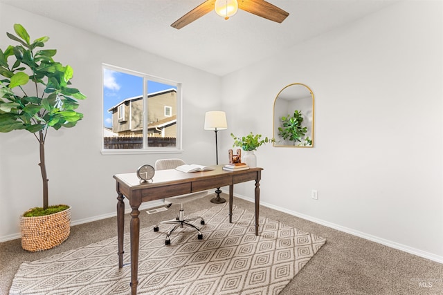 home office with ceiling fan, baseboards, and carpet flooring