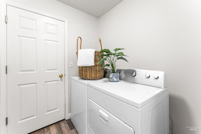 laundry area featuring laundry area, dark wood-style floors, and washing machine and clothes dryer