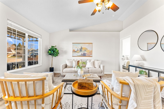 living room with lofted ceiling, a ceiling fan, baseboards, and wood finished floors