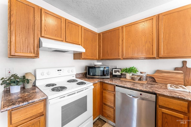 kitchen with stainless steel appliances, brown cabinets, under cabinet range hood, and a textured ceiling