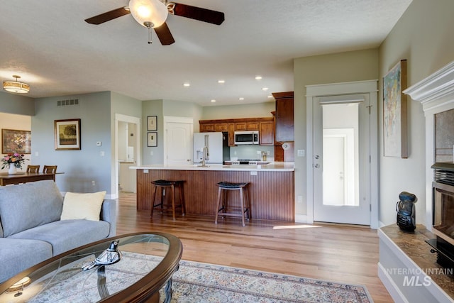 16089 N Basin Way, Boise, ID 83714 - living area with light wood-type flooring, a ceiling fan, baseboards, and recessed lighting