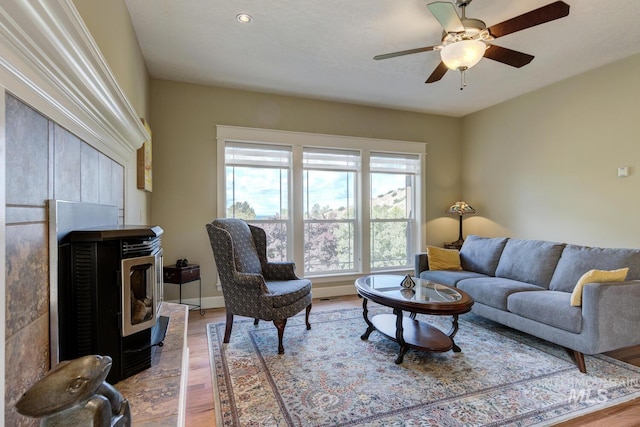 16089 N Basin Way, Boise, ID 83714 - living room with wood finished floors, a ceiling fan, and a wood stove