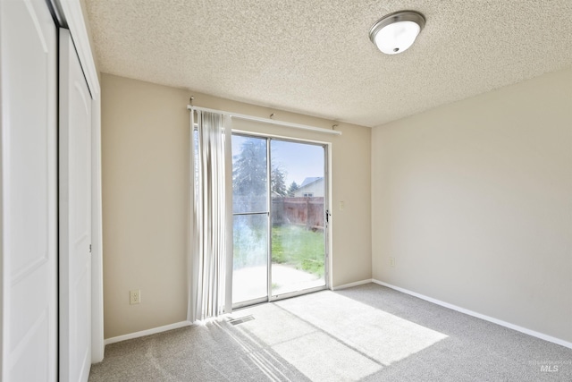 10397 10399 W Irving Ct, Boise, ID 83704 - unfurnished bedroom with a textured ceiling, visible vents, baseboards, access to outside, and carpet floors