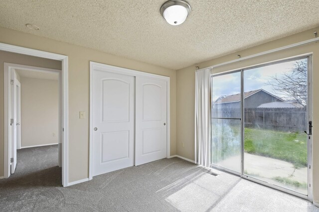 10397 10399 W Irving Ct, Boise, ID 83704 - unfurnished bedroom featuring carpet floors, baseboards, a closet, and access to exterior