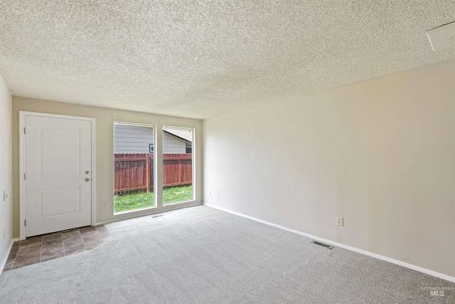 10397 10399 W Irving Ct, Boise, ID 83704 - empty room featuring baseboards, a textured ceiling, visible vents, and carpet