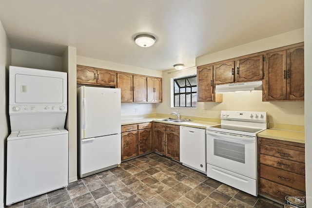 10397 10399 W Irving Ct, Boise, ID 83704 - kitchen featuring light countertops, a sink, stacked washer and clothes dryer, under cabinet range hood, and white appliances