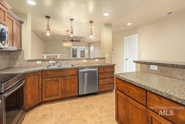 kitchen with brown cabinetry, visible vents, appliances with stainless steel finishes, and a sink