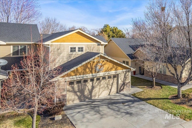 craftsman-style home featuring concrete driveway and a garage