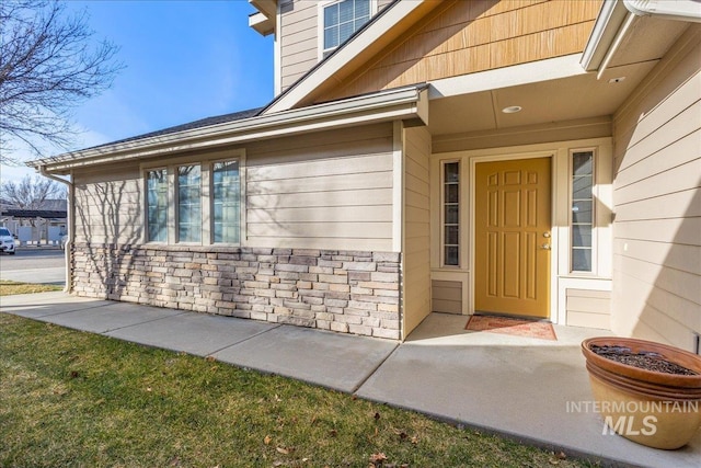 property entrance with stone siding