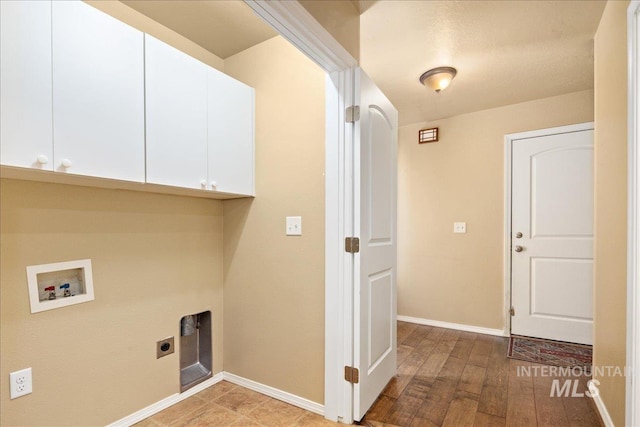 laundry area with hookup for a washing machine, baseboards, light wood-style flooring, cabinet space, and electric dryer hookup