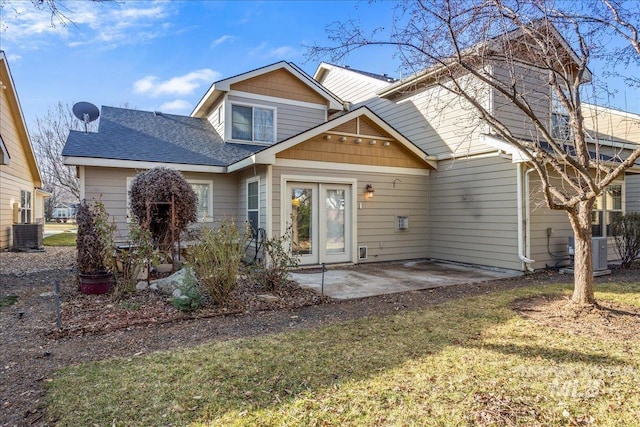 back of property featuring cooling unit, a patio, and roof with shingles