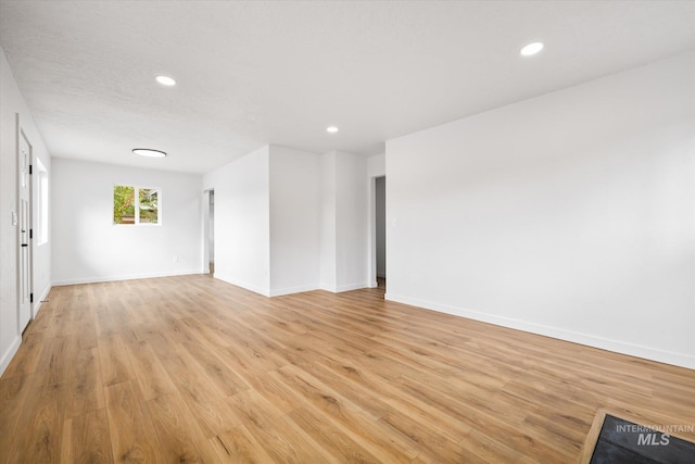 unfurnished room with light wood-type flooring