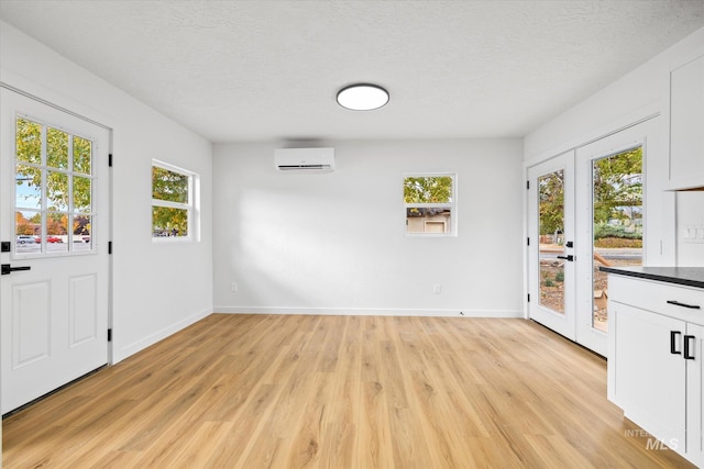 interior space featuring french doors, plenty of natural light, and light wood-type flooring