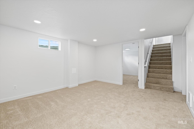 basement featuring light colored carpet