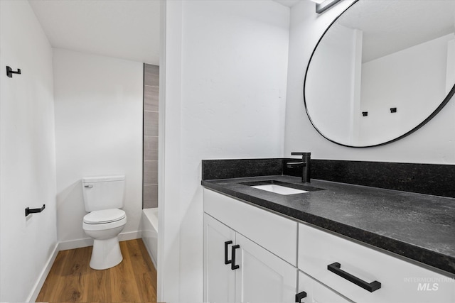 bathroom with vanity, toilet, and hardwood / wood-style flooring