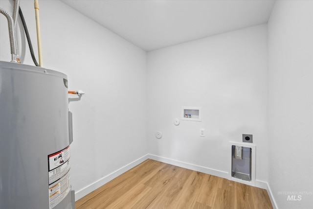 clothes washing area with hardwood / wood-style floors, water heater, hookup for a washing machine, and electric dryer hookup