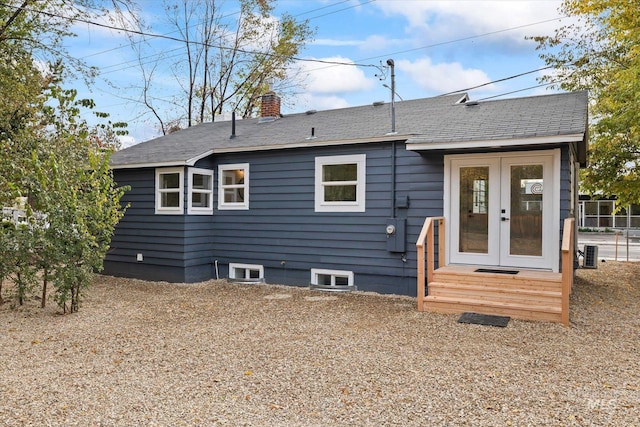 rear view of property with french doors and central AC