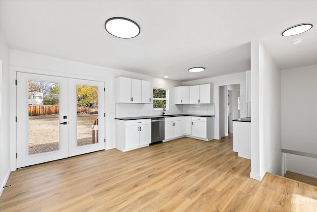 kitchen with french doors, white cabinetry, dishwasher, and light hardwood / wood-style floors