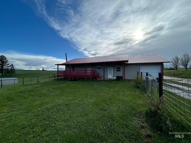 1585 Woodside Rd, Winchester, ID 83555 - rear view of property with a garage, metal roof, driveway, and a view of countryside