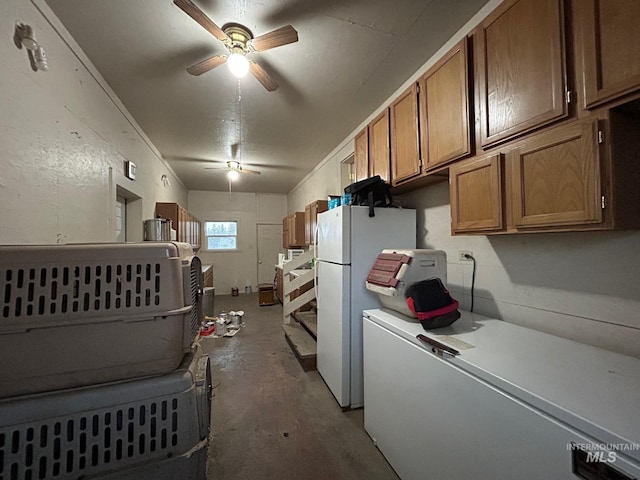 1585 Woodside Rd, Winchester, ID 83555 - kitchen with white fridge, concrete flooring, a ceiling fan, freestanding refrigerator, and brown cabinets