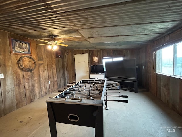 1585 Woodside Rd, Winchester, ID 83555 - recreation room featuring wood walls, a ceiling fan, and concrete flooring