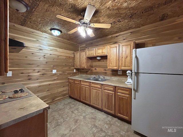 1585 Woodside Rd, Winchester, ID 83555 - kitchen featuring freestanding refrigerator, wood walls, a sink, ceiling fan, and light countertops