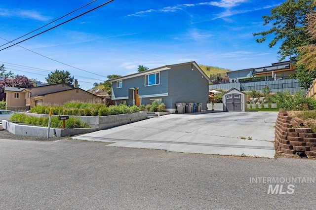 view of front of home featuring a storage shed