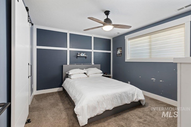 bedroom with carpet, ceiling fan, and a textured ceiling