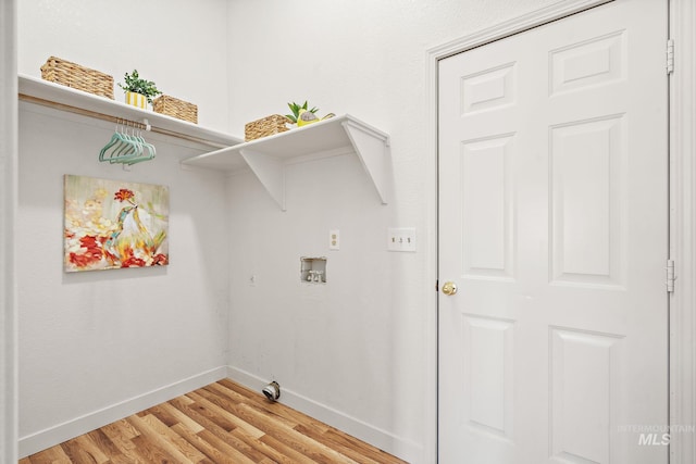 laundry room with hardwood / wood-style floors and washer hookup