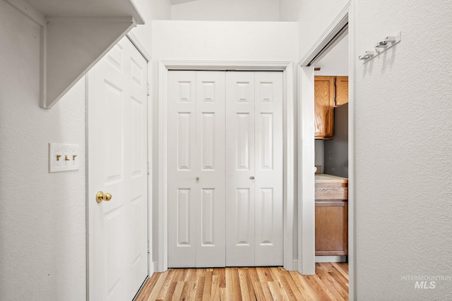 hallway with light hardwood / wood-style floors