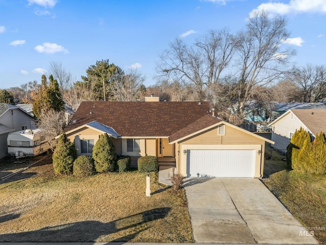 single story home with a front yard and a garage