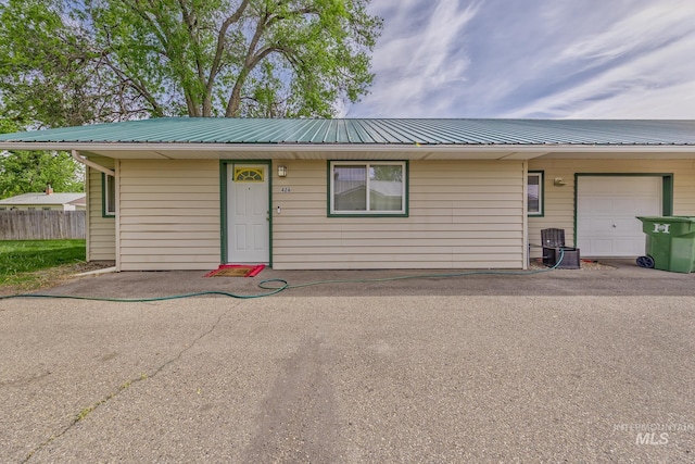 426 S Utah, Fruitland, ID 83619 - ranch-style house with metal roof, fence, and an attached garage