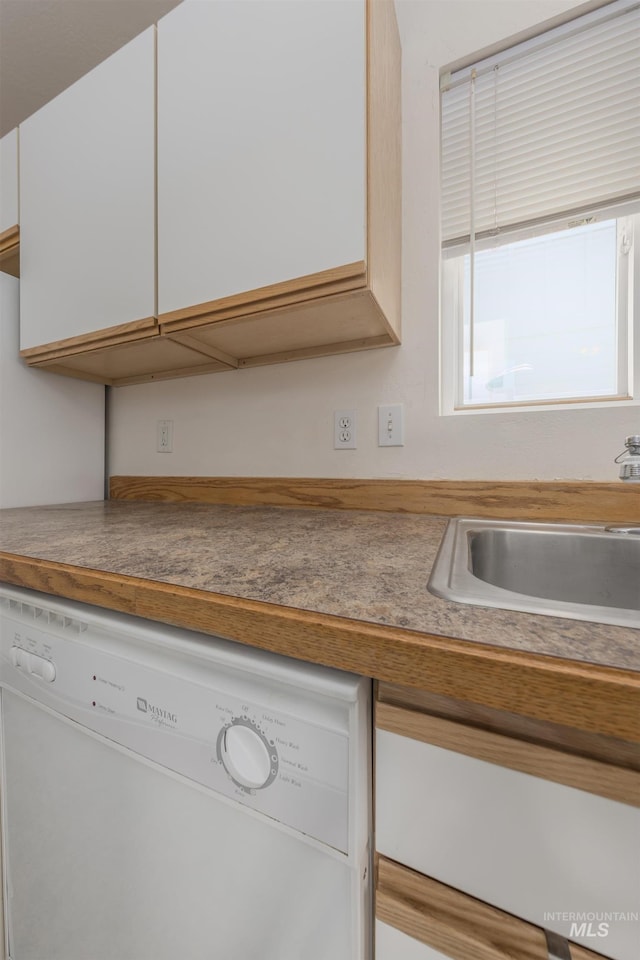 426 S Utah, Fruitland, ID 83619 - kitchen featuring white dishwasher, a sink, and white cabinets