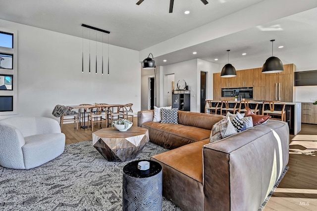 living area featuring light wood finished floors, recessed lighting, and ceiling fan