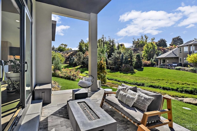 view of patio featuring an outdoor living space with a fire pit