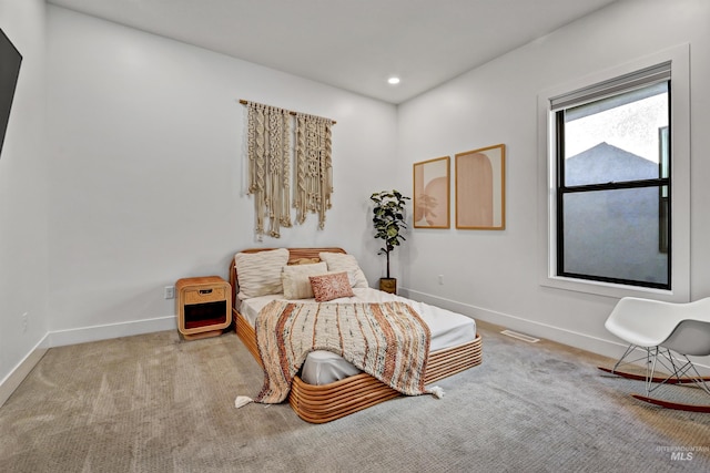 carpeted bedroom featuring recessed lighting, visible vents, and baseboards