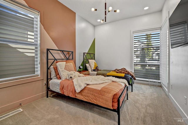 carpeted bedroom with recessed lighting, visible vents, baseboards, and a chandelier