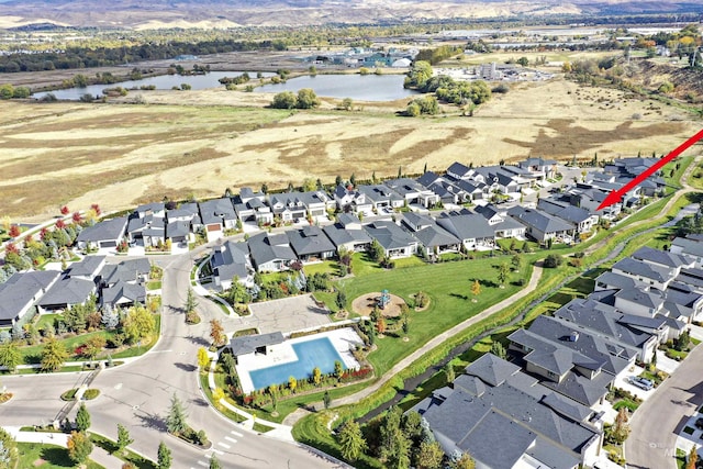 drone / aerial view featuring a residential view and a water view