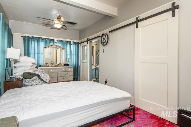 bedroom featuring a barn door and ceiling fan