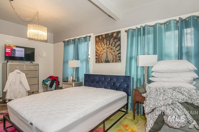 bedroom featuring beamed ceiling and a notable chandelier