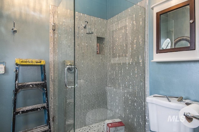 bathroom featuring toilet and an enclosed shower